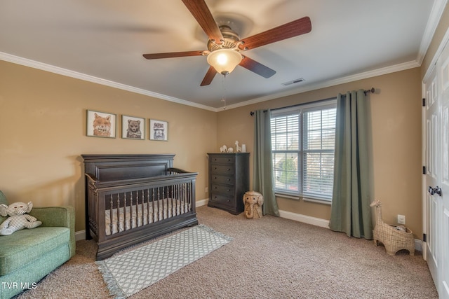 carpeted bedroom with baseboards, visible vents, ceiling fan, ornamental molding, and a nursery area