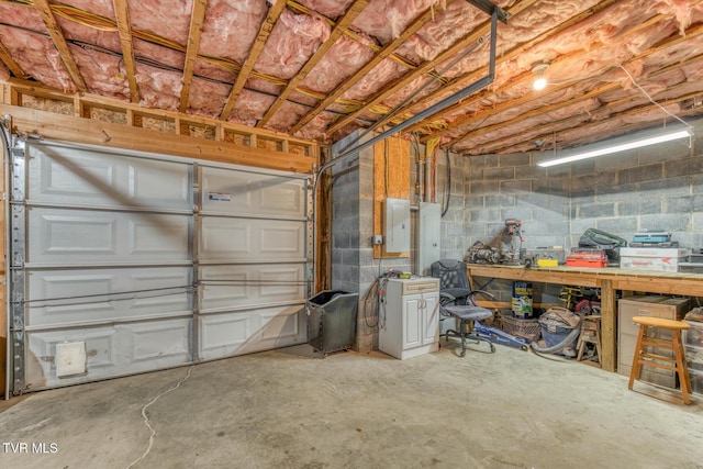 garage with electric panel and a workshop area