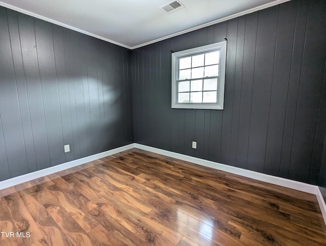 unfurnished room featuring ornamental molding and hardwood / wood-style flooring