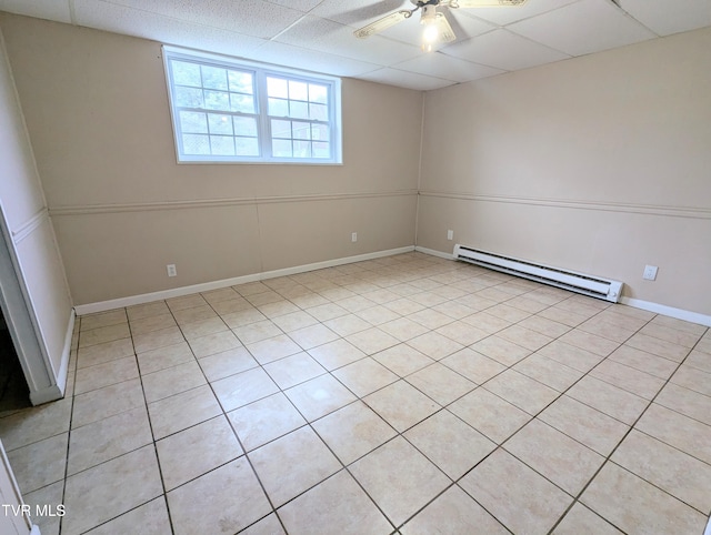 spare room with ceiling fan, a paneled ceiling, and a baseboard heating unit