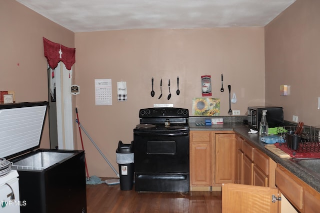 kitchen with electric range and dark wood-type flooring