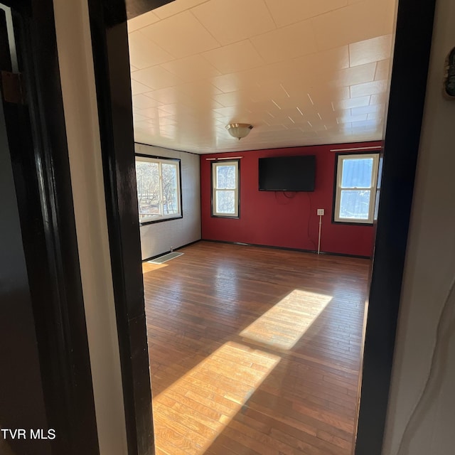 unfurnished room featuring visible vents and wood finished floors