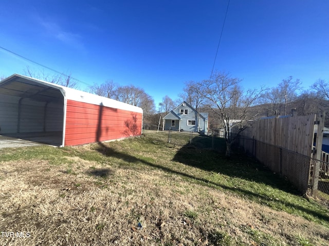 view of yard with fence and a detached carport