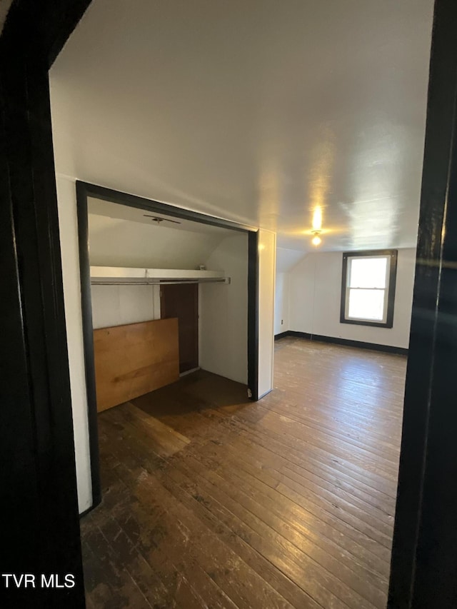 interior space with lofted ceiling and hardwood / wood-style floors