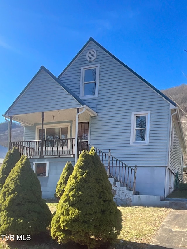 bungalow-style house featuring a porch and stairs