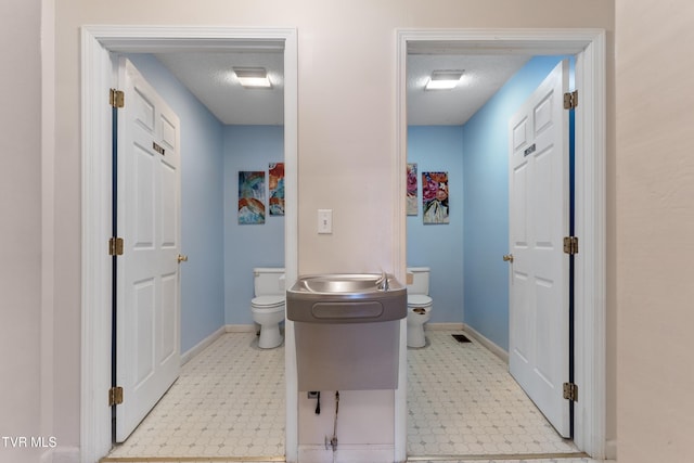 bathroom featuring toilet and a textured ceiling