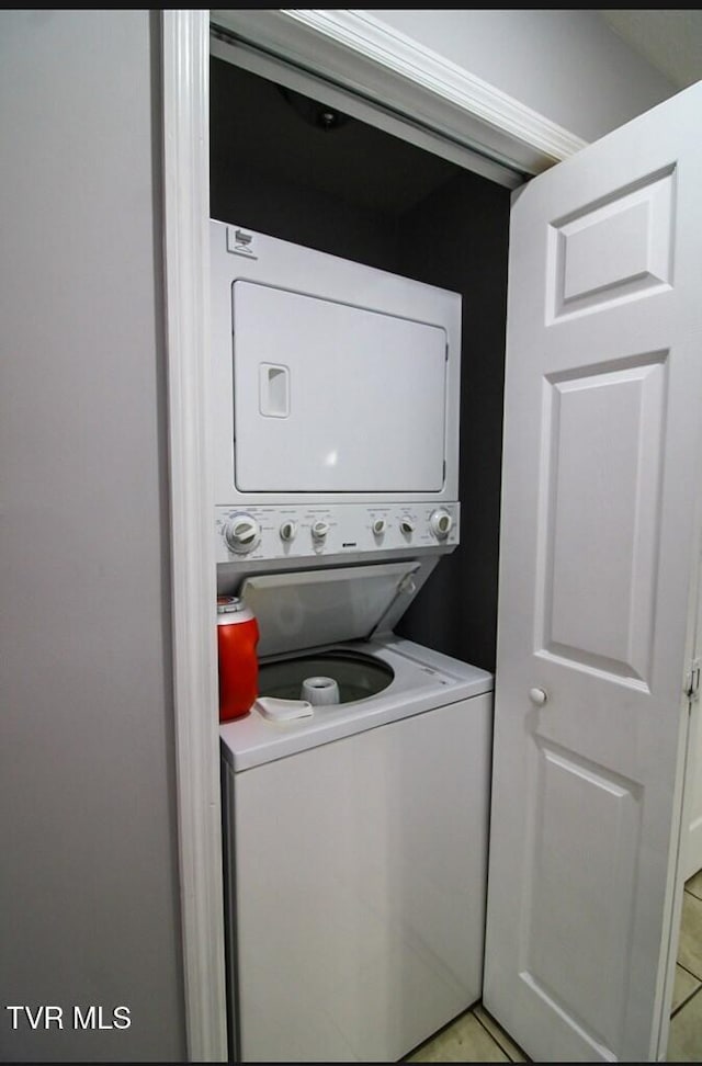 laundry area featuring stacked washer / dryer