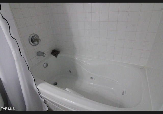 bathroom with a tub to relax in