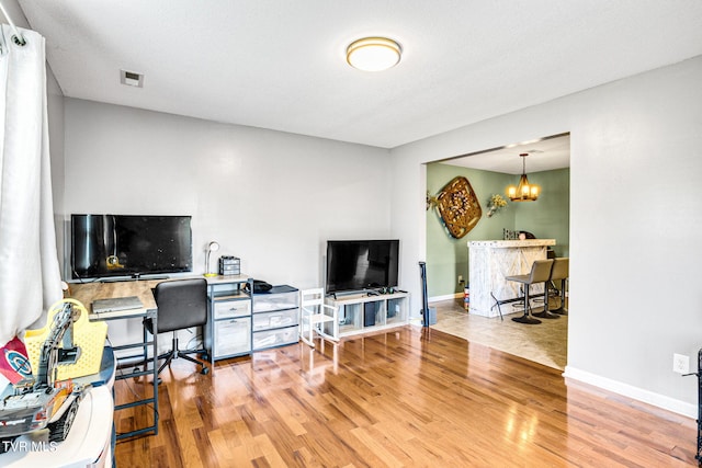 office area featuring hardwood / wood-style floors and an inviting chandelier