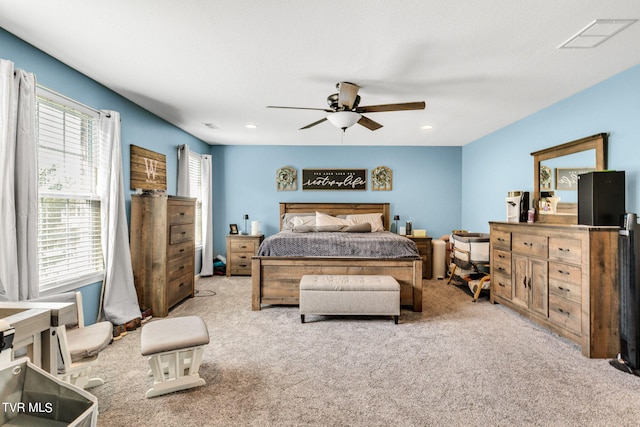 bedroom with light carpet and ceiling fan