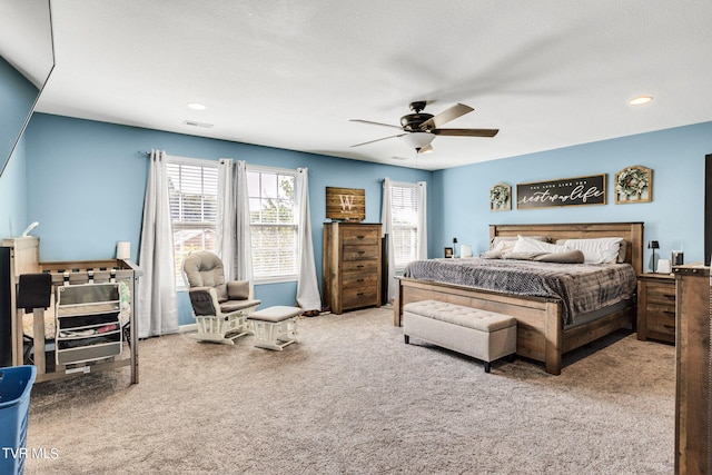 bedroom featuring light carpet and ceiling fan