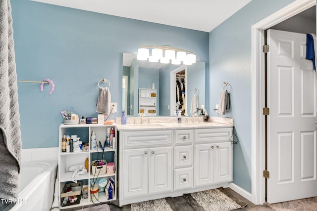 bathroom with a tub to relax in and vanity