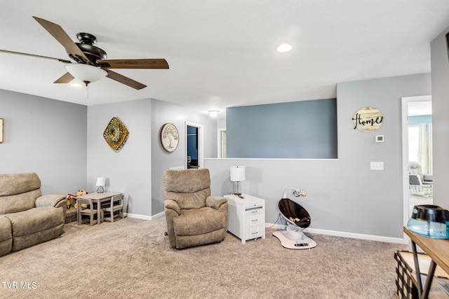 sitting room featuring ceiling fan and light carpet