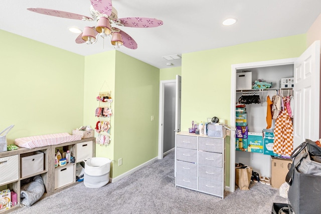 carpeted bedroom featuring ceiling fan and a closet