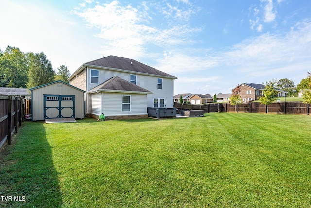 back of property featuring a hot tub, a shed, and a lawn