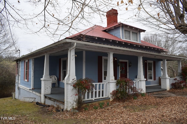 view of side of home featuring covered porch