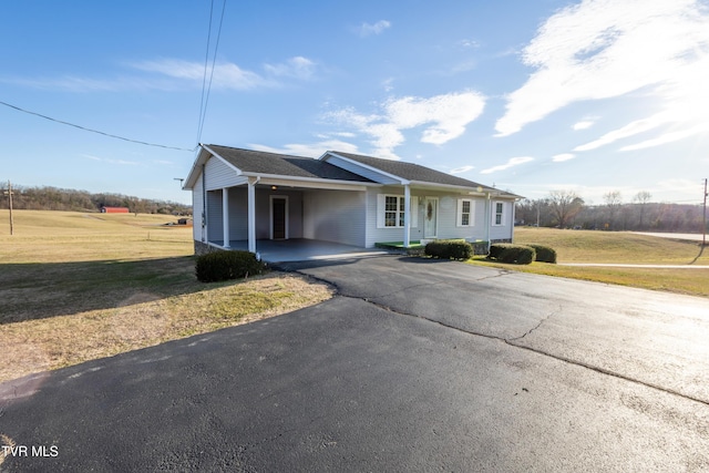 view of front of property with driveway, an attached carport, and a front yard