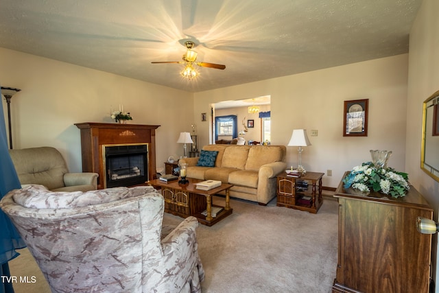 carpeted living room featuring a fireplace and a ceiling fan