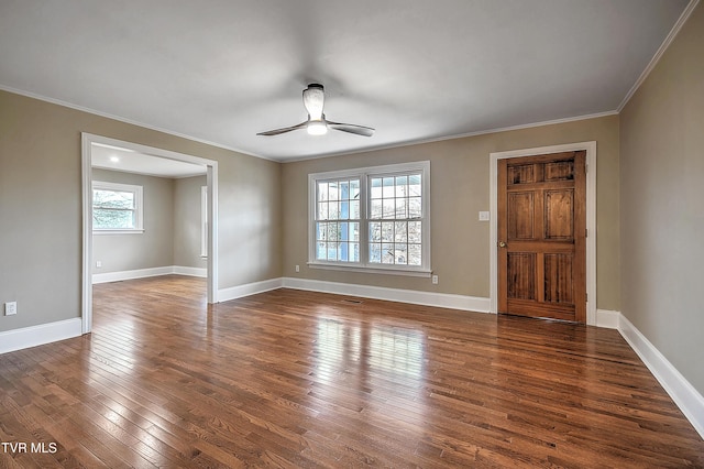 interior space featuring crown molding, dark wood-style flooring, a ceiling fan, and baseboards