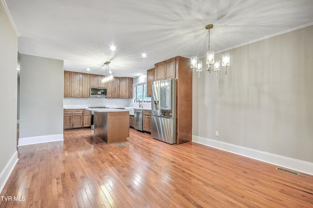 kitchen with visible vents, stainless steel appliances, light countertops, light wood-style floors, and a chandelier