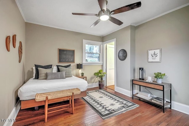 bedroom with crown molding, baseboards, ceiling fan, and wood finished floors