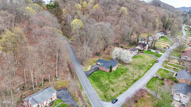 aerial view featuring a wooded view