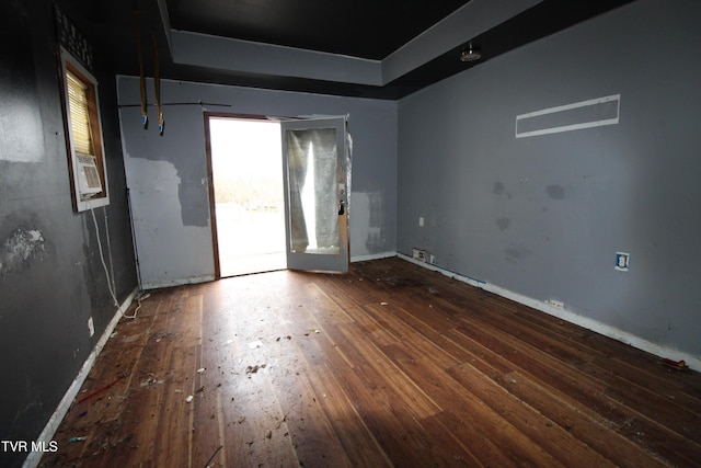 spare room with dark wood-type flooring