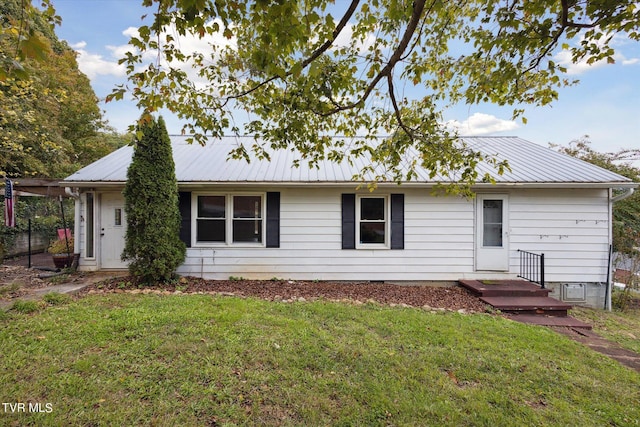 rear view of property featuring a yard