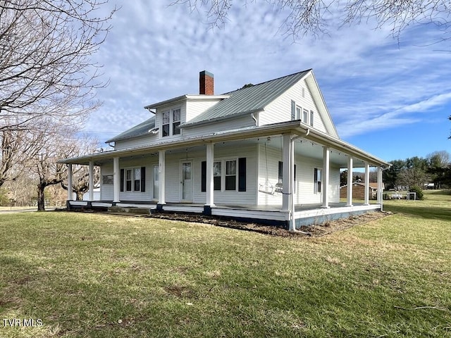 exterior space with covered porch and a lawn