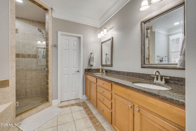 full bath with ornamental molding, a stall shower, and a sink