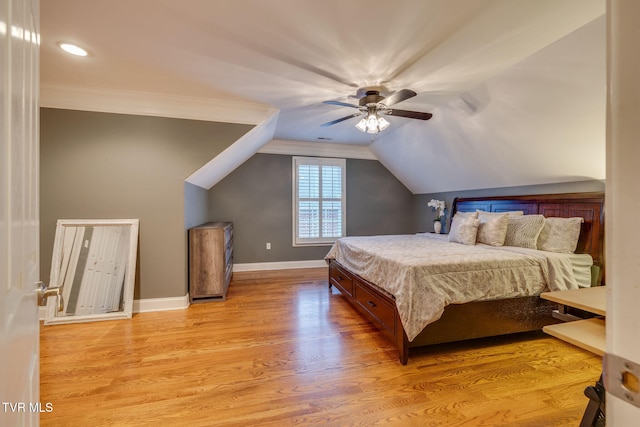 bedroom featuring baseboards, lofted ceiling, ceiling fan, ornamental molding, and light wood-type flooring