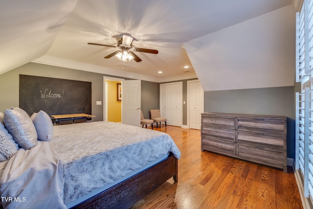 bedroom featuring ceiling fan, wood finished floors, vaulted ceiling, crown molding, and recessed lighting