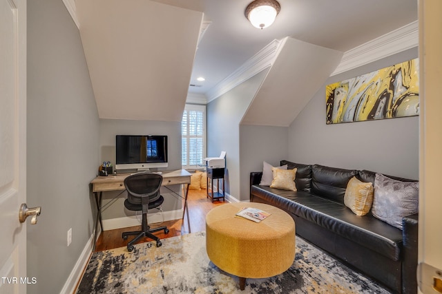 office featuring vaulted ceiling, crown molding, baseboards, and wood finished floors