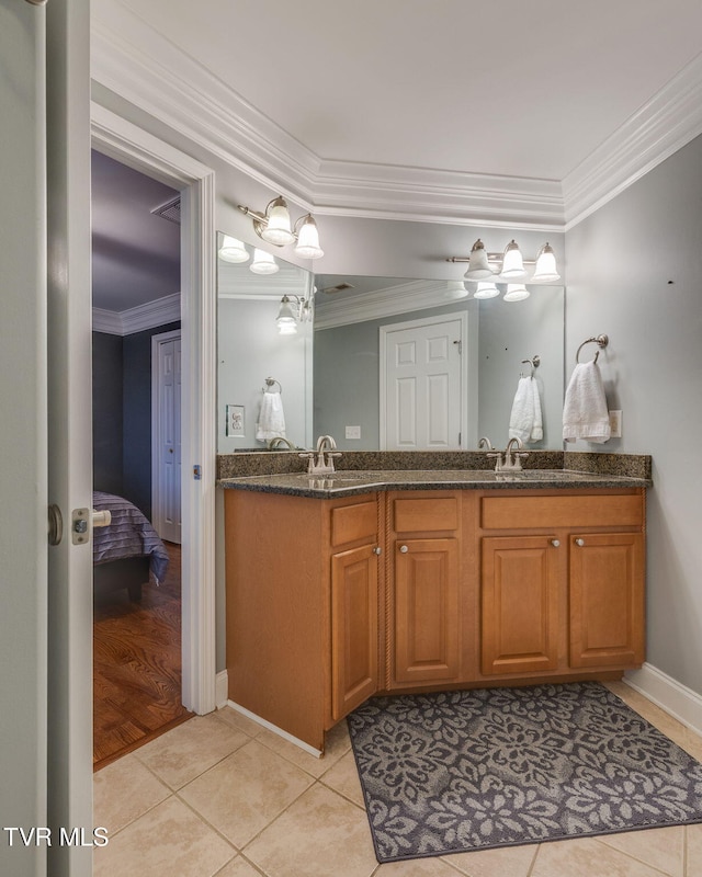 full bath with tile patterned flooring, connected bathroom, a sink, ornamental molding, and double vanity