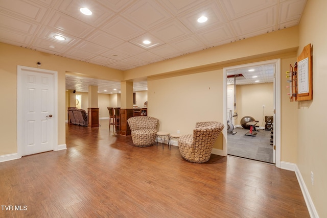 sitting room with recessed lighting, wood finished floors, an ornate ceiling, and baseboards