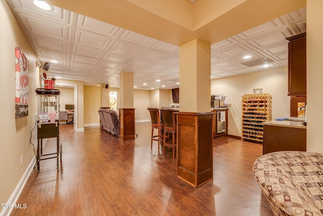 bar with an ornate ceiling, recessed lighting, baseboards, and wood finished floors