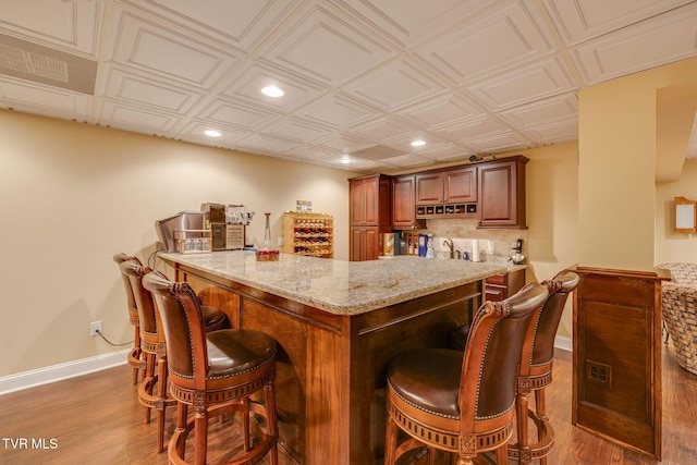 bar with an ornate ceiling, recessed lighting, a dry bar, and baseboards