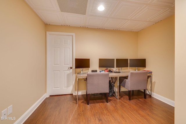 home office with an ornate ceiling, baseboards, and wood finished floors