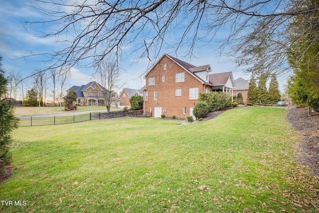 view of yard featuring a fenced backyard and a residential view