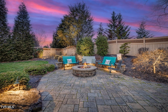 view of patio / terrace featuring an outdoor fire pit and a fenced backyard