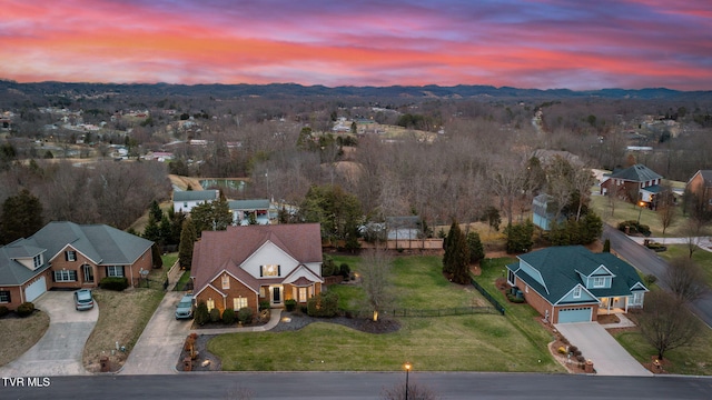 aerial view at dusk featuring a residential view