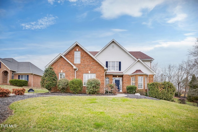 traditional-style home featuring brick siding and a front yard