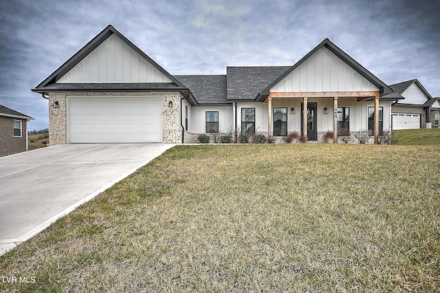 view of front of property featuring a front lawn, a porch, and a garage