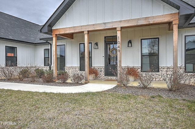 doorway to property featuring a lawn