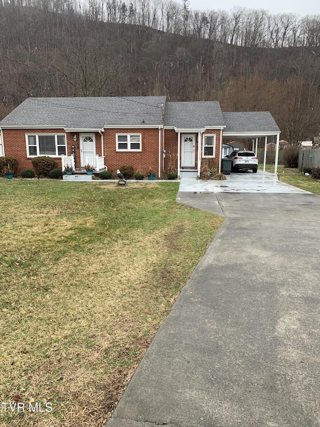 single story home with a front lawn and a carport