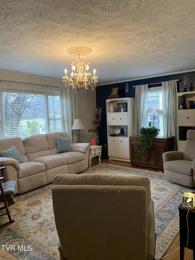 living room with a notable chandelier and a textured ceiling