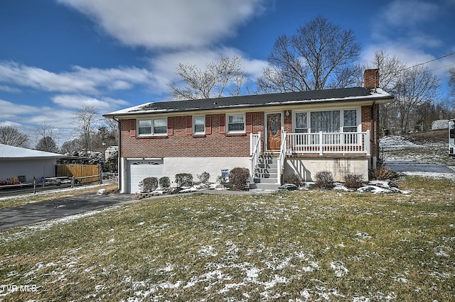 view of front of home featuring aphalt driveway, brick siding, a chimney, a lawn, and a garage