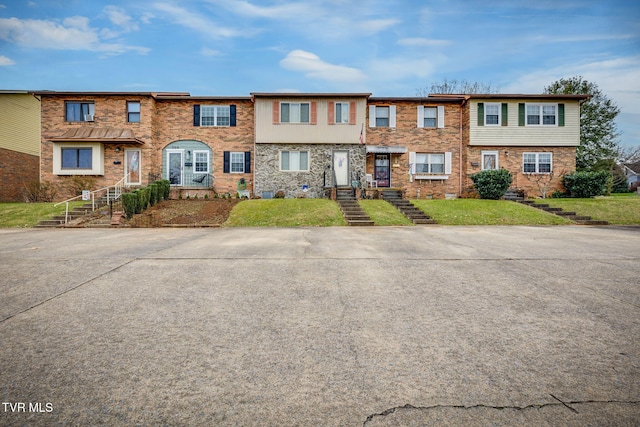 townhome / multi-family property with brick siding