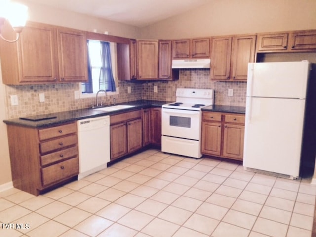 kitchen with sink, white appliances, vaulted ceiling, tasteful backsplash, and light tile patterned flooring