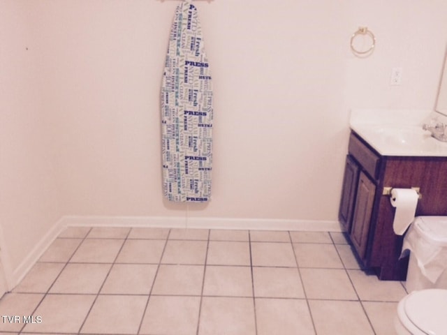 bathroom with vanity, toilet, and tile patterned floors